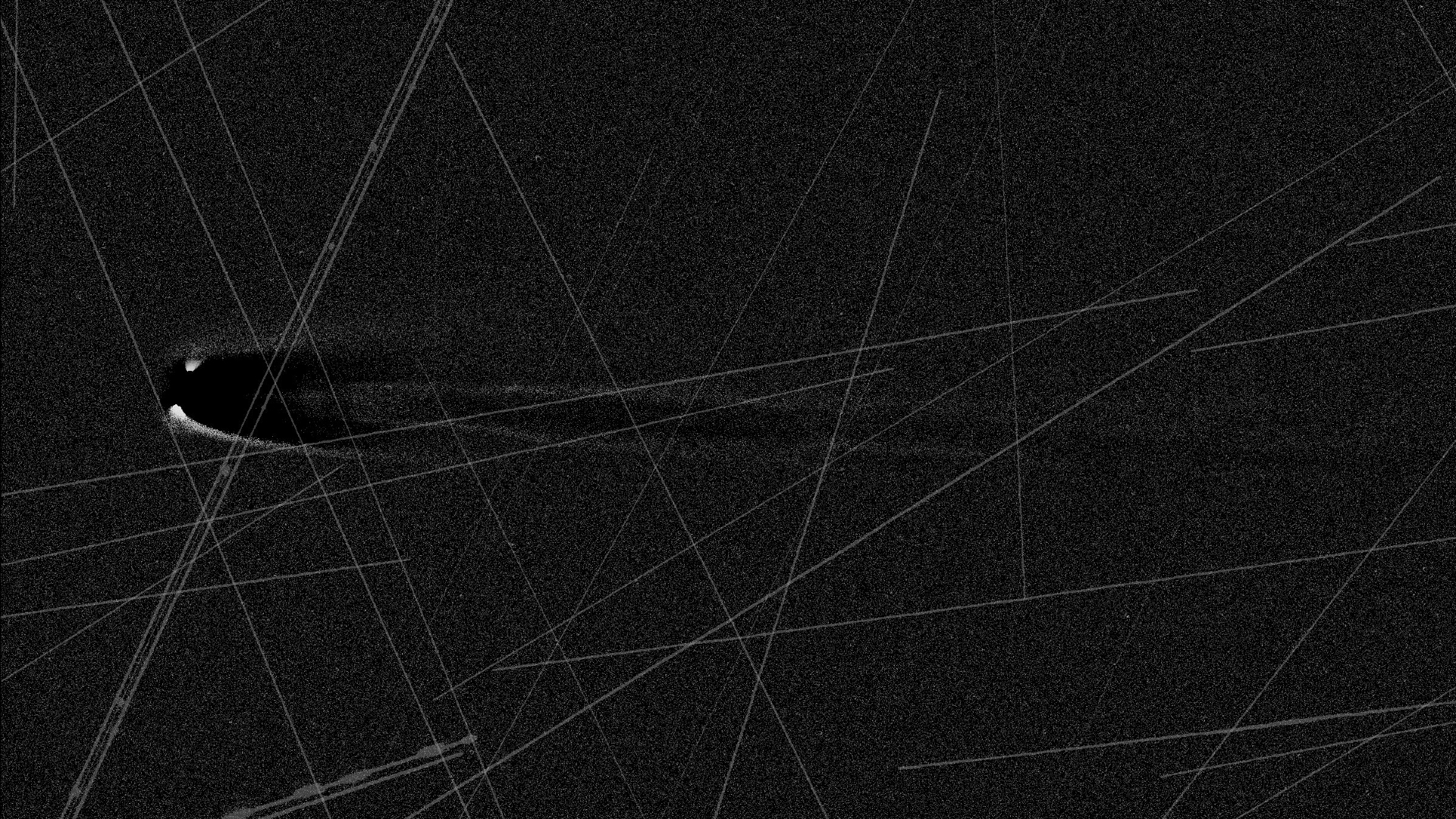 An image of a comet in black and white with lines streaking across the image.