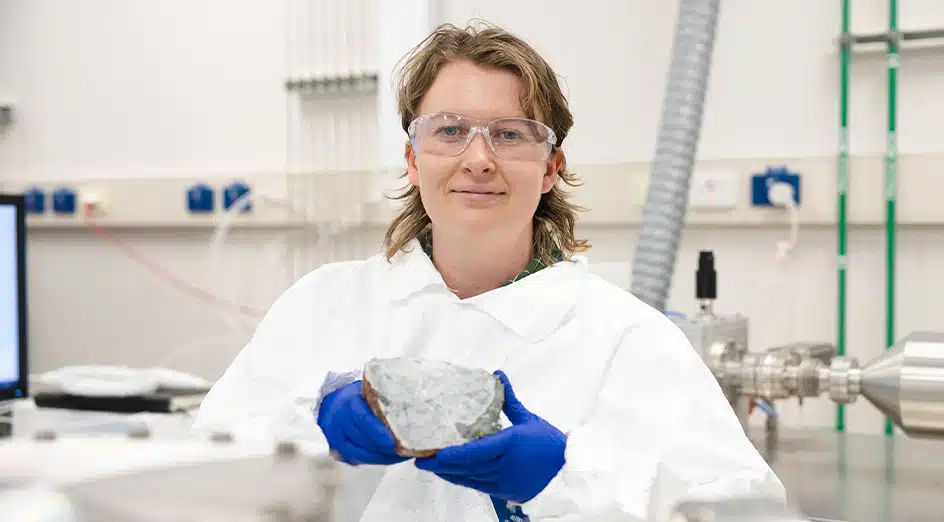 Matilda Boyce, Ph.d. Student At The University Of Western Australia, Holding An Ancient Rock Sample In The Lab