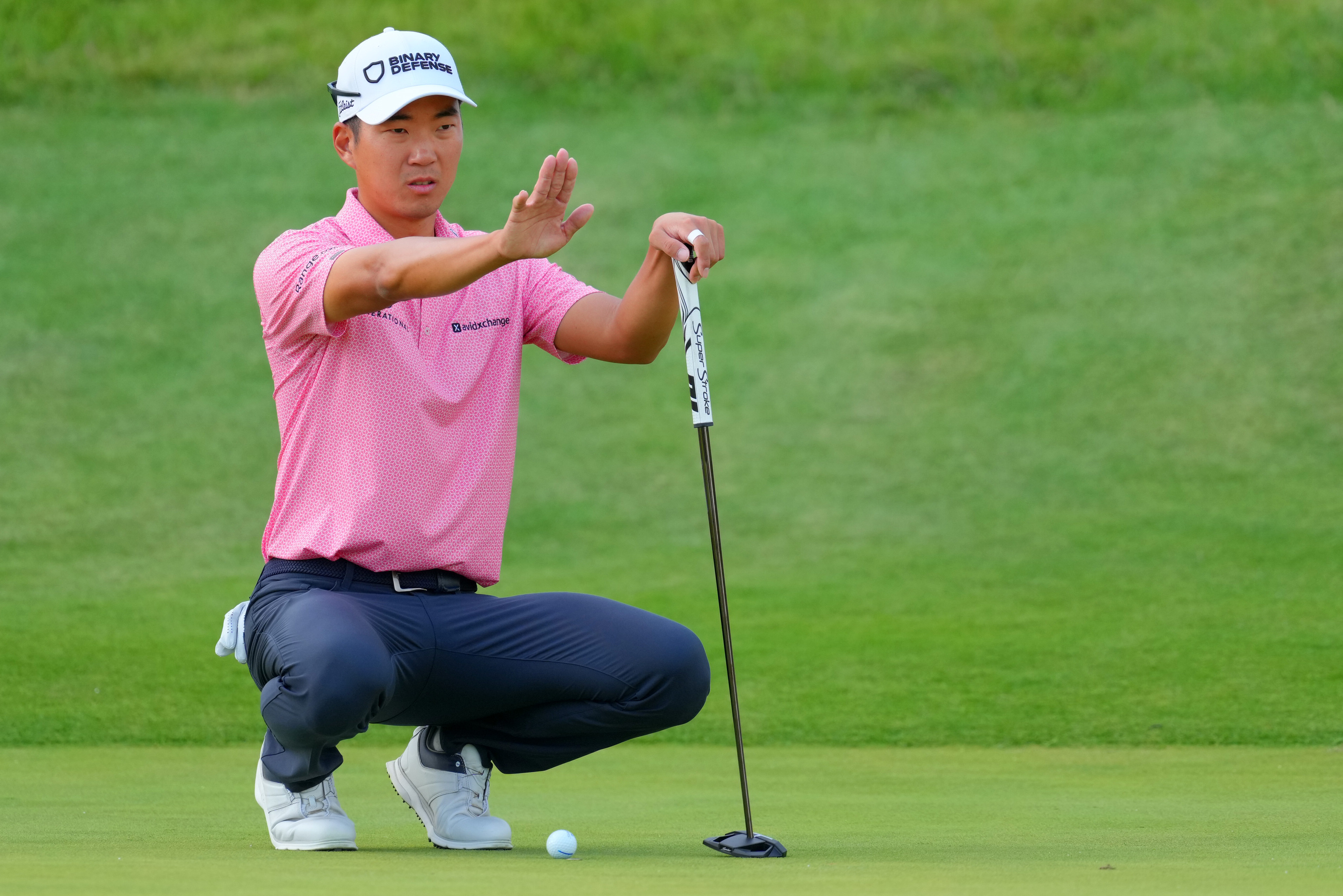 Michael Kim lines up a putt