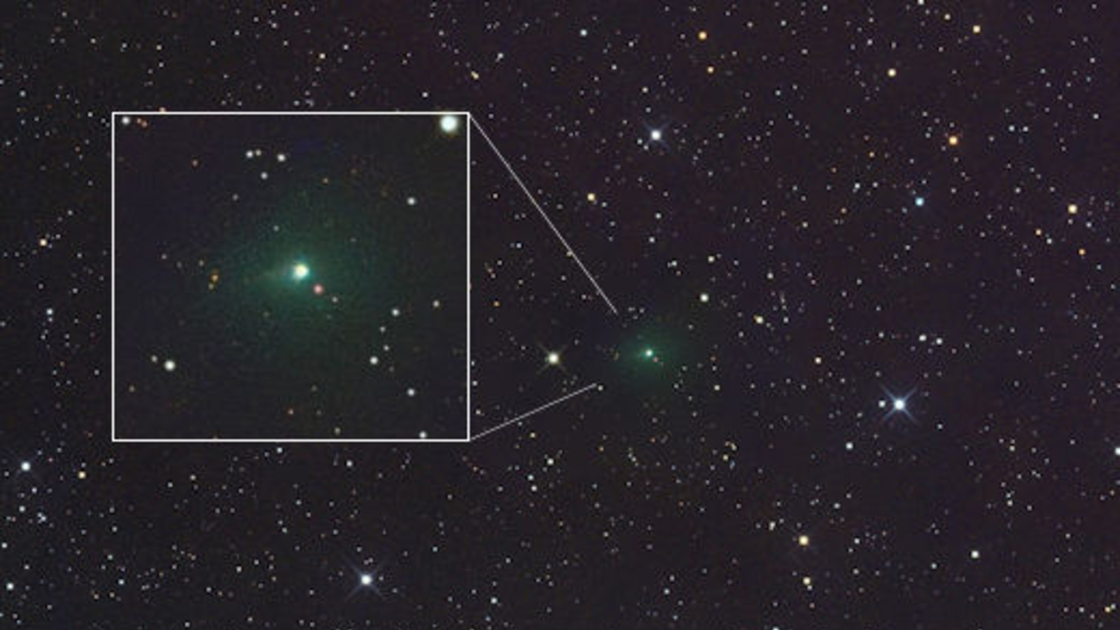A space photo of a green comet surrounded by stars with a boxout highlighting the comet closer
