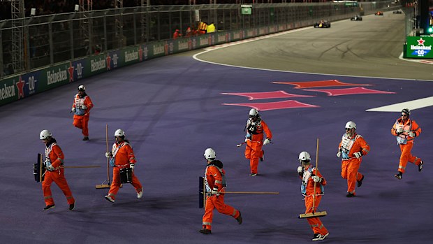 Marshals were cleaning up debris on track during the opening laps of the race. 