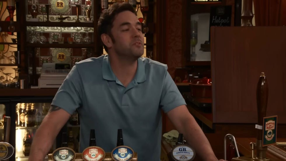 coronation street ben driscoll, behind the rovers bar in a blue polo