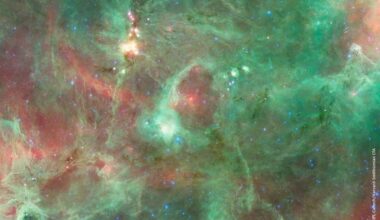 The 'Diamond Ring' structure glows brightly in infrared and is about 20 light-years in diameter. It's a bubble blown by a massive star, when its powerful stellar winds and radiation cleared the region around it. Unlike other star-blown bubbles, this one is only a slowly-expanding, flat ring. Image Credit: NASA/JPL-Caltech/Harvard-Smithsonian CfA