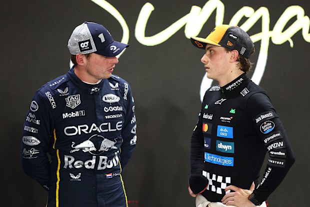 Oscar Piastri (R) speaks with Max Verstappen (L).