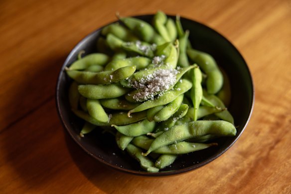 Edamame, served with nori salt and a side of shichimi.