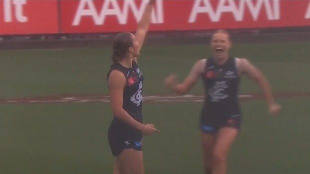 Mia Austin, cousin of the young cricketer Ben Austin who died in a training accident, points to the sky in tribute after her goal.