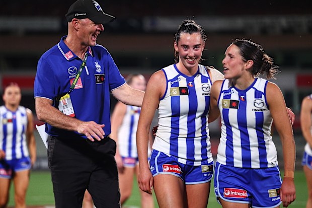 From left: North Melbourne coach Darren Crocker with players Blaithin Bogue and Bella Eddey after the qualifying final win over Hawthorn.