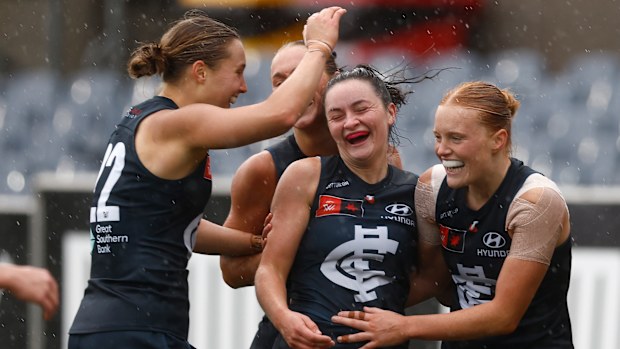 Mia Austin, Erone Fitzpatrick, and Sophie McKay of the Blues celebrate a goal during the 2025 AFLW first elimination final against the West Coast Eagles.
