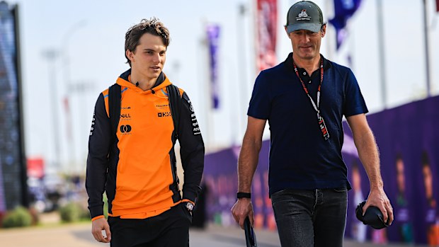 Oscar Piastri of Australia and McLaren walks with manager Mark Webber in the paddock during the Sprint/qualifying ahead of the F1 Grand Prix of Qatar at Lusail International Circuit on November 30, 2024 in Lusail City, Qatar. (Photo by Kym Illman/Getty Images)