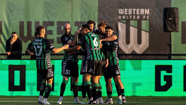 Western United FC players celebrate a goal.