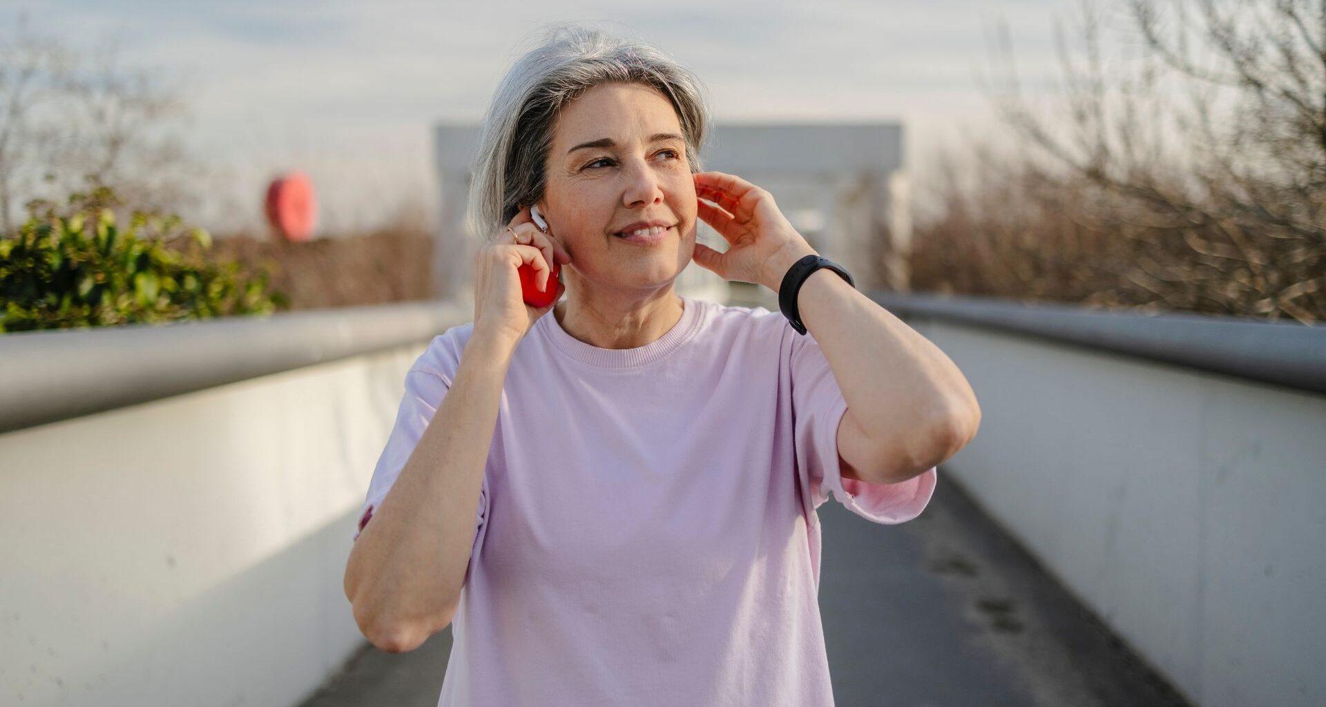 Woman doing walking HIIT workout as the best exercise for over-70s along path in city