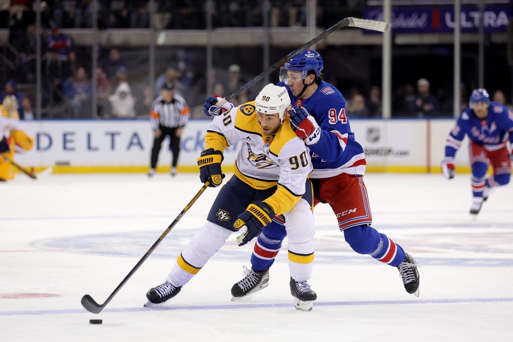 Nashville Predators center Ryan O'Reilly (90) playing the puck against New York Rangers right wing Gabe Perreault (94) during the first period.
