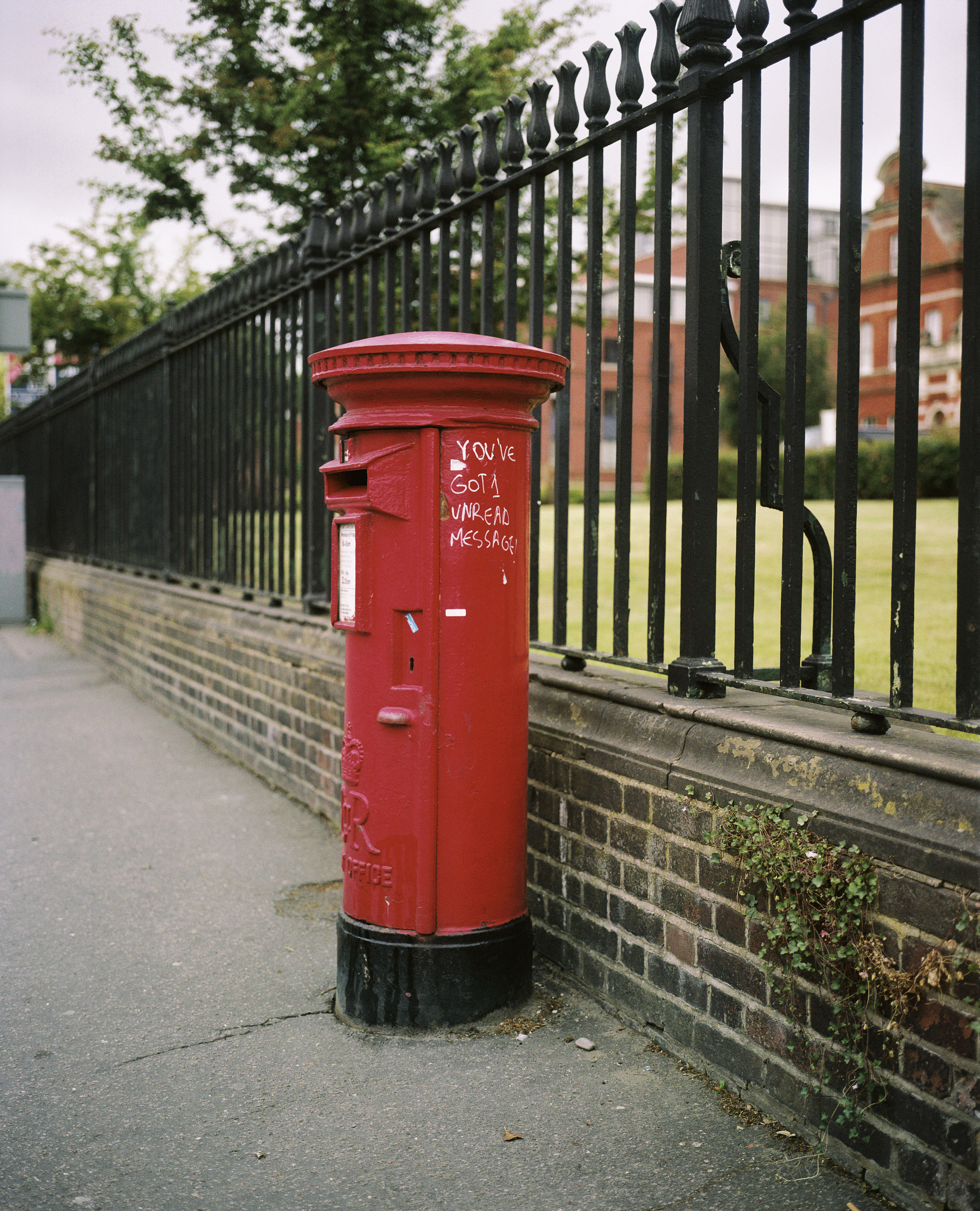 Red British post box with "You've got 1 unread message" written on it.