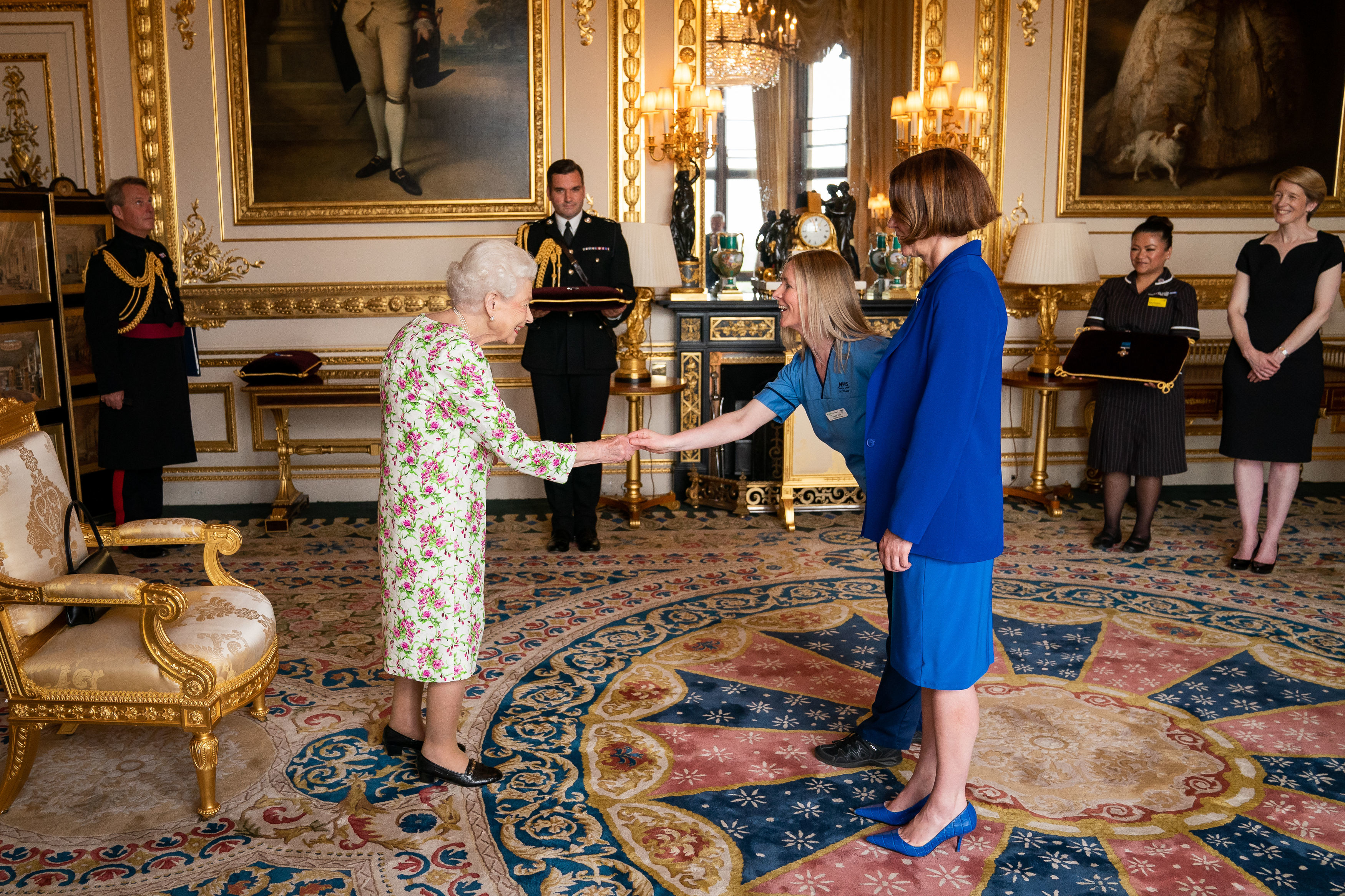 Queen Elizabeth II presenting the George Cross to representatives of the National Health Service: Ms Caroline Lamb, Chief Executive NHS Scotland, and Ms Eleanor Grant, Palliative Care Nurse, Specialist University Hospital Wishaw, NHS Lanarkshire, at Windsor Castle.