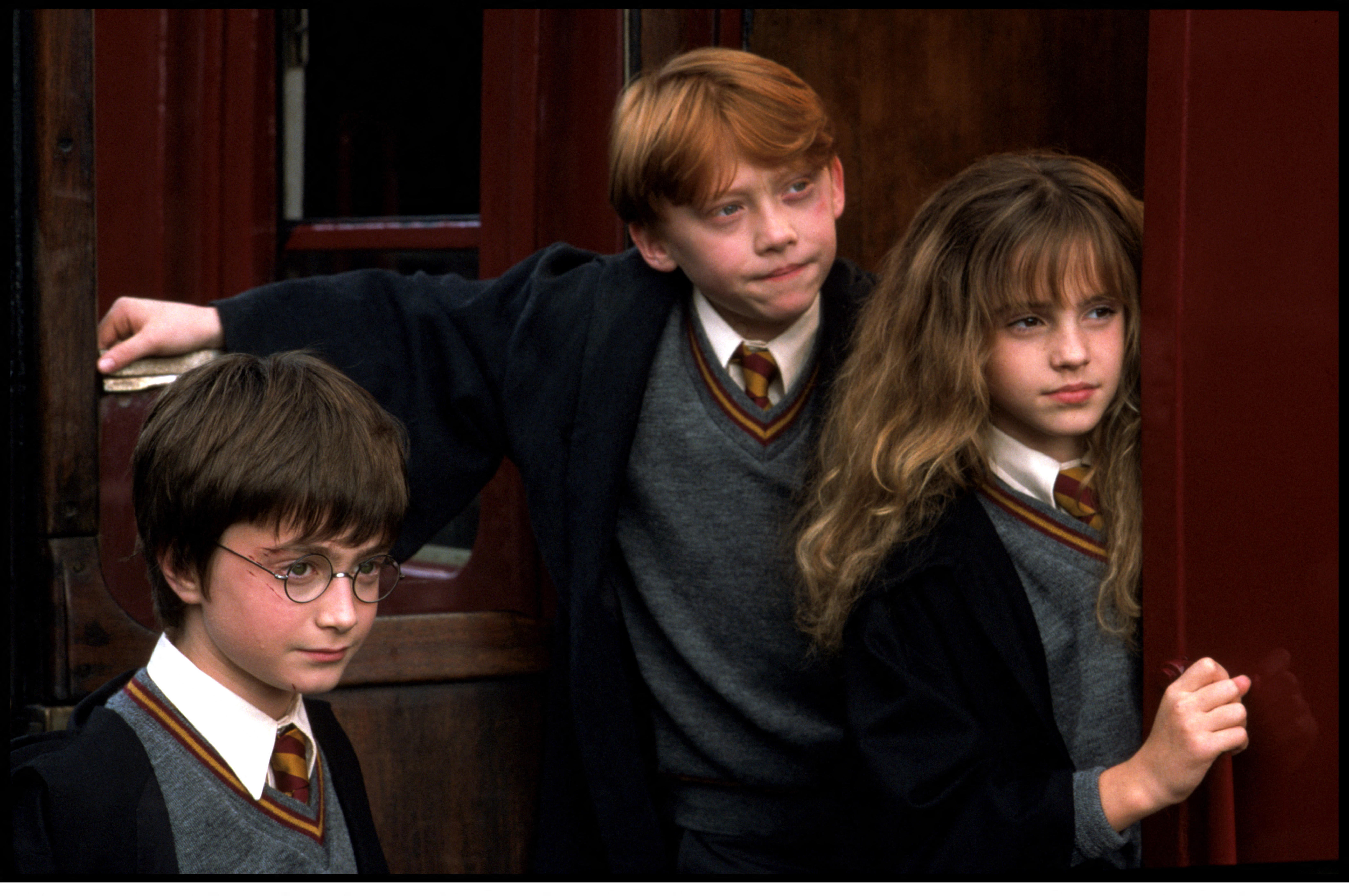Daniel Radcliffe, Rupert Grint, and Emma Watson as Harry Potter, Ron Weasley, and Hermione Granger.