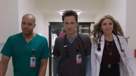 Hulu Three cast member walking down a hospital corridor