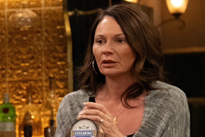 A shellshocked Chas stands behind the bar of The Woolpack in Emmerdale