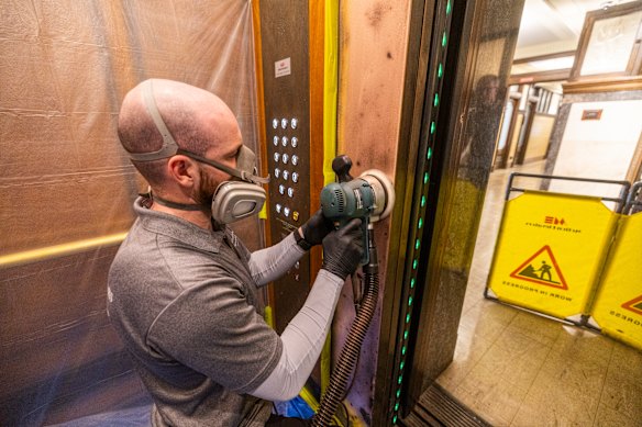 Lifting spirits: Martini working on elevators in the Manchester Unity building.