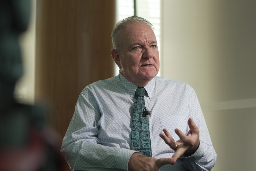 man in shirt and tie counts on fingers