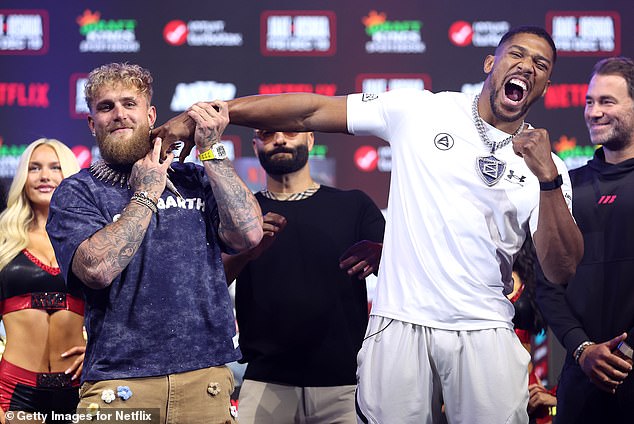 Anthony Joshua pretends to punch a smiling Jake Paul ahead of their £140m Miami showdown
