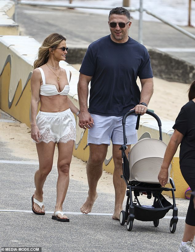 Sam Burgess and his wife Lucy looked every inch the happy family as they soaked up the Australian sunshine during a relaxed beach outing in Sydney on Sunday