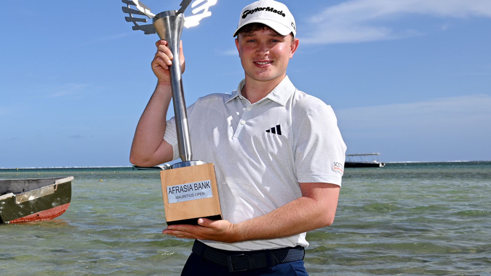 In-form Jayden Schaper shows off his trophy on the beach in Mauritius