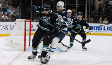 Utah Mammoth left wing Lawson Crouse, front, fights for the puck against Winnipeg Jets defenseman Logan Stanley (64) during the first period of an NHL hockey game, Sunday, Dec. 21, 2025, in Salt Lake City. (Melissa Majchrzak / The Associated Press)