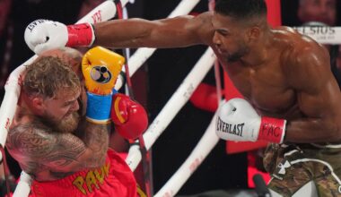 Anthony Joshua punches Jake Paul during their heavyweight boxing match