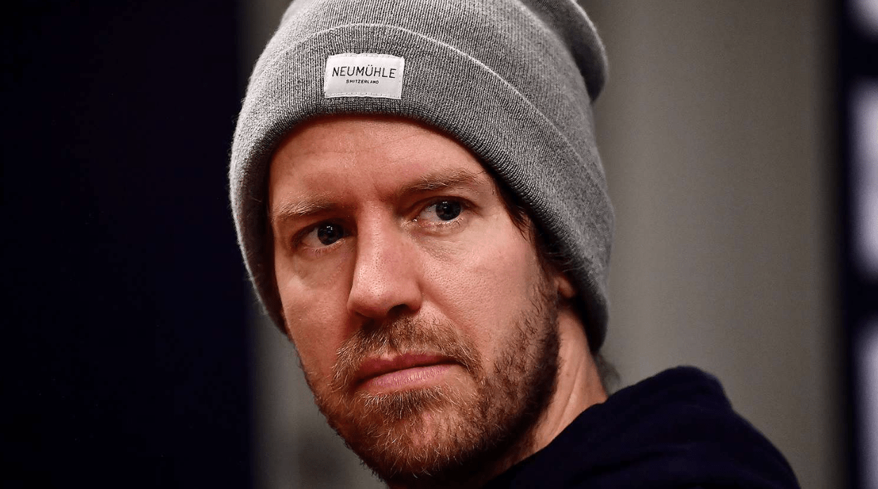 Vettel looking forward wearing a grey hat