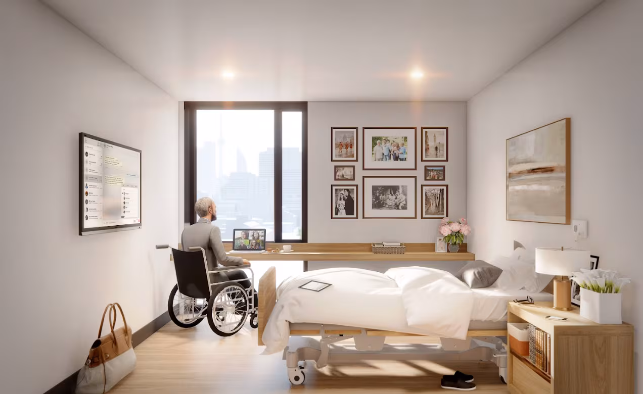 A rendering of the room design at the Rekai Centre's Cherry Place. A man is depicted sitting at a desk by a window. The room features a bed, picture frames and storage space. 