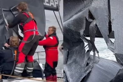 LawConnect crew taping sail tears at first light.