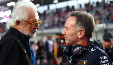 Two men, Horner and Briatore, conversing at a racetrack.