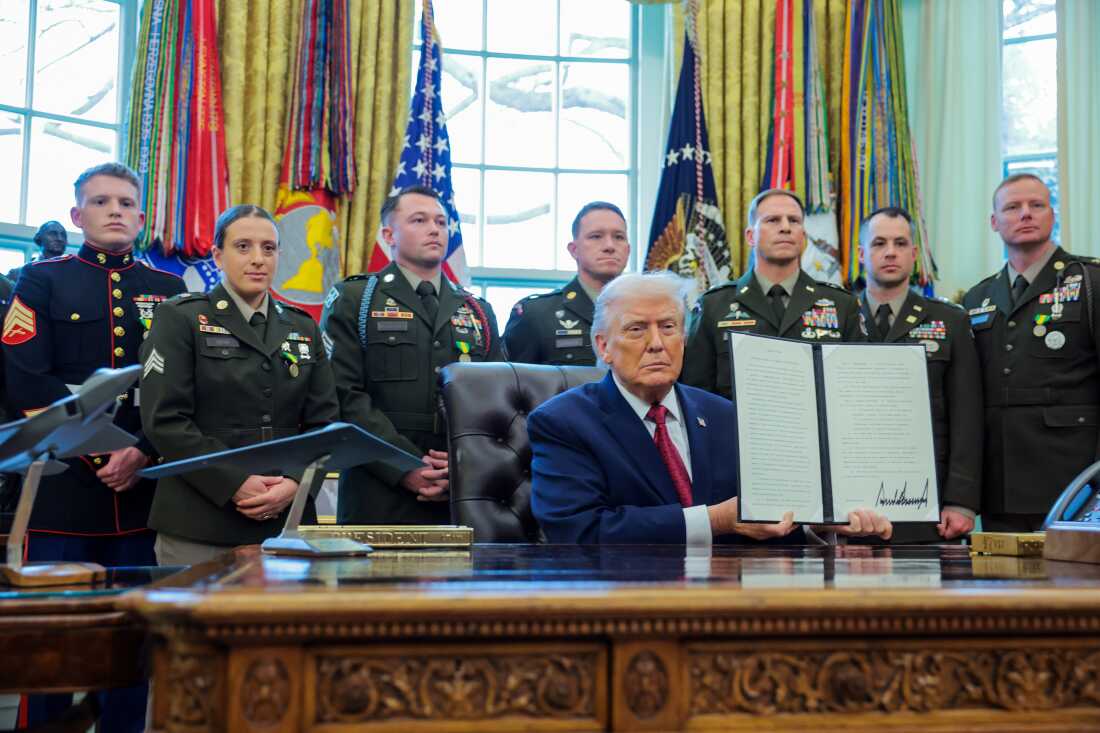 President Donald Trump poses with a recently signed executive order classifying fentanyl as a "weapon of mass destruction," during a ceremony in the Oval Office of the White House on Dec. 15.