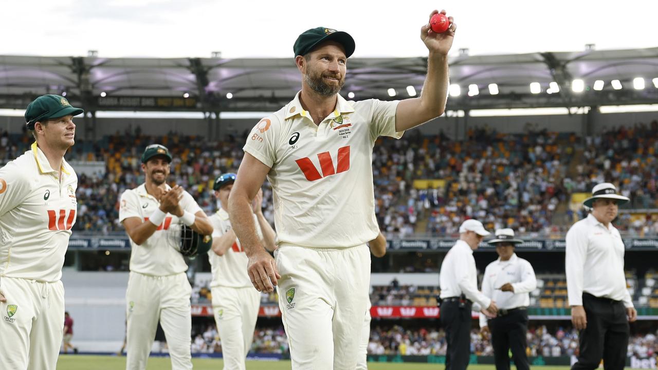 Michael Neser of Australia holds the ball aloft after taking five wickets.