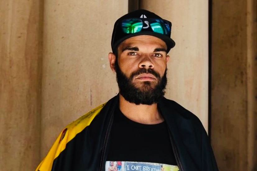 Man with beard dressed in Aboriginal colours
