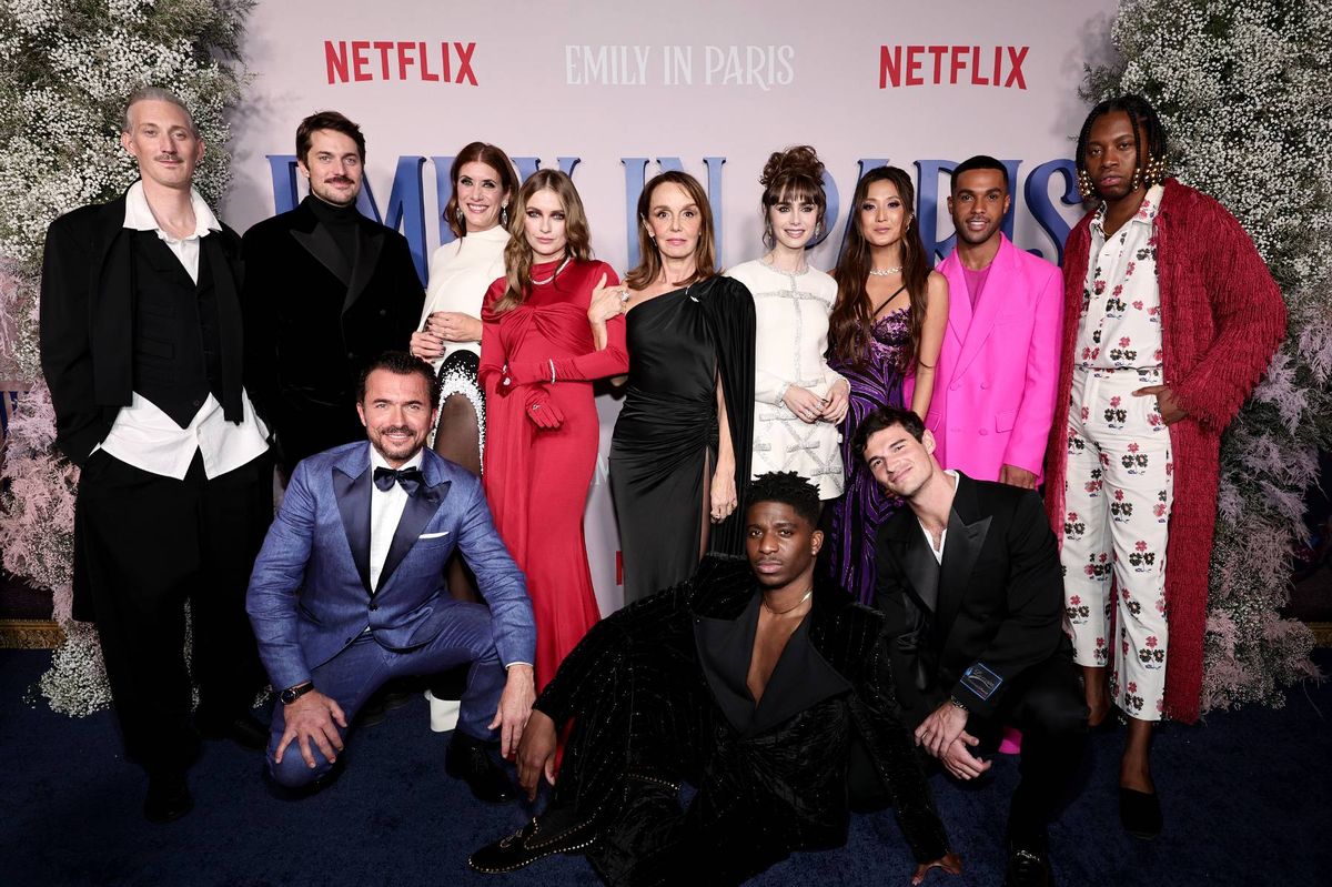 (L-R) Bruno Gouery, Lucas Bravo, William Abadie, Kate Walsh, Camille Razat, Philippine Leroy-Beaulieu, Samuel Arnold, Lily Collins, Ashley Park, Paul Forman, Lucien Laviscount, and Jeremy O. Harris attend the Emily In Paris French Consulate Red Carpet at French Consulate