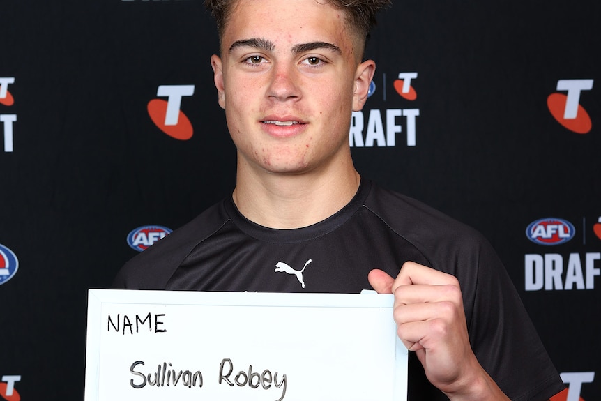 Sullivan Robey poses for a headshot at the AFL draft combine