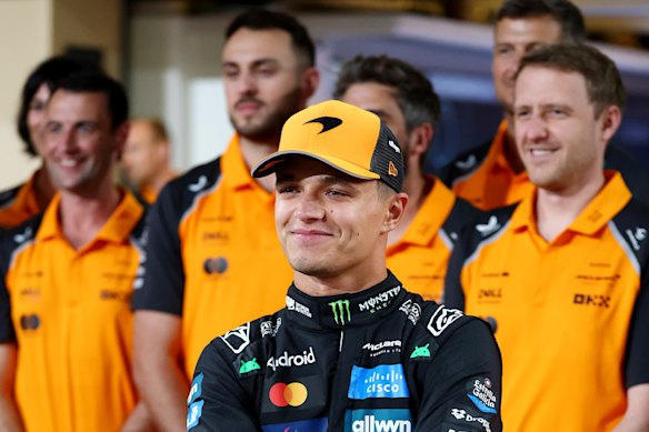Lando Norris and members of the McLaren team in Abu Dhabi.