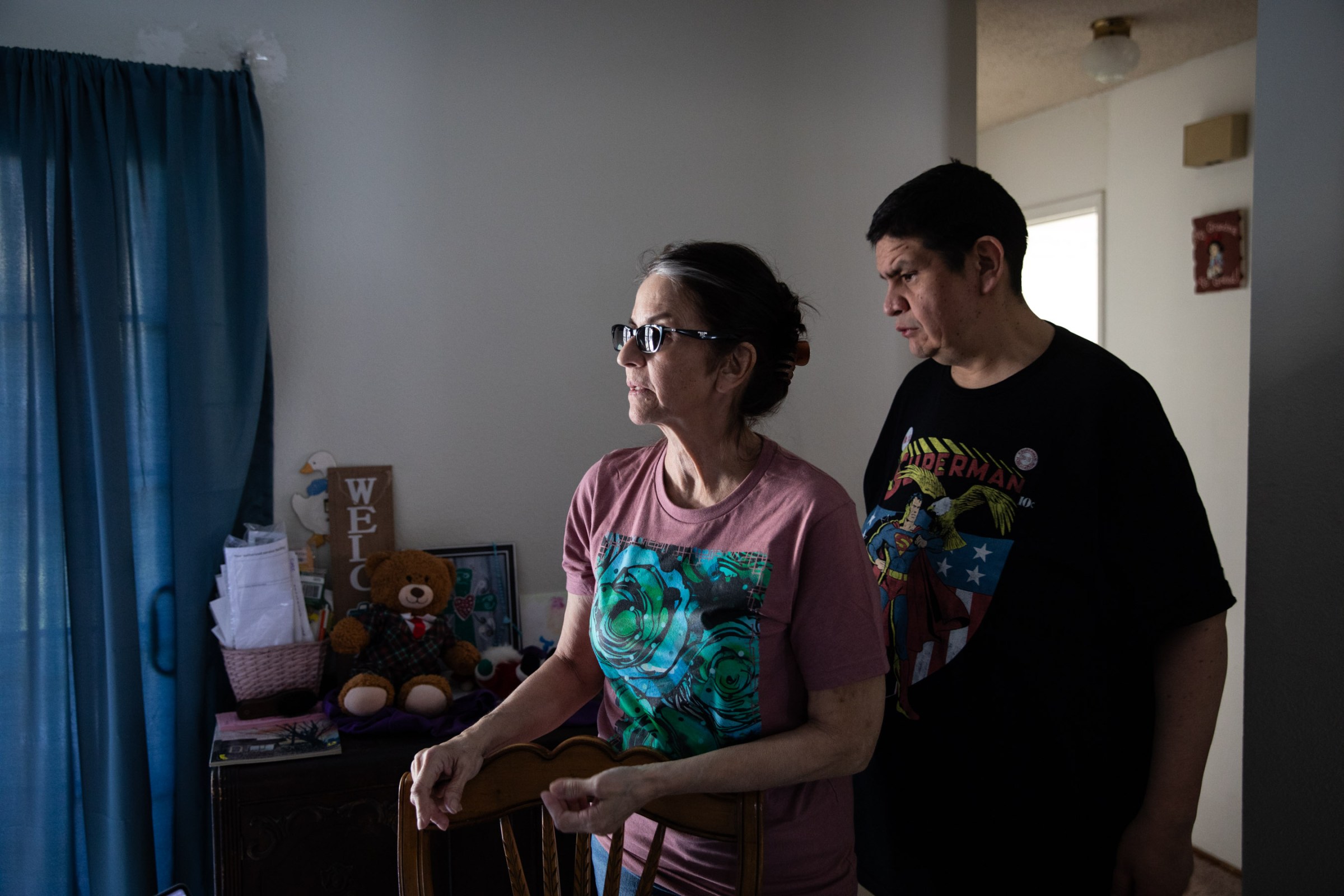 Two people in a room looking off to the left of the photo