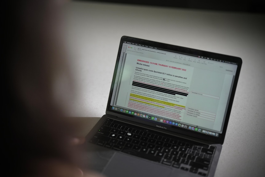 Close up of the embargoed media release about Sports Bet on a laptop with changes and redactions throughout the text.