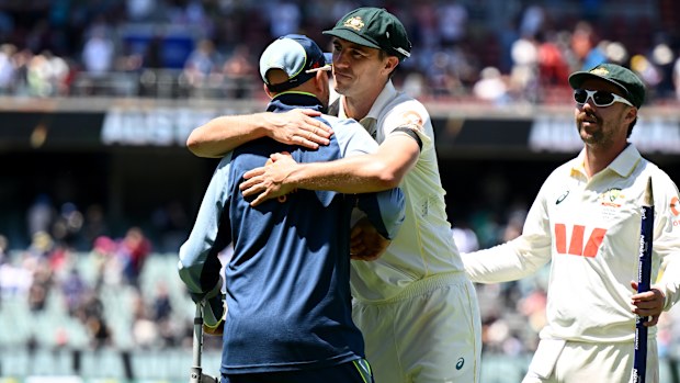 Pat Cummins embraces Nathan Lyon after securing victory in the third Test at the Adelaide Oval.