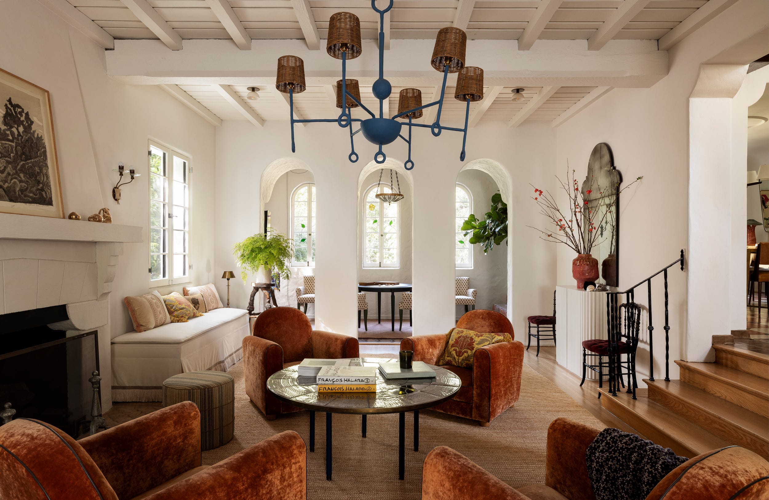 Living room featuring a chandelier, seating area, and decorative elements.