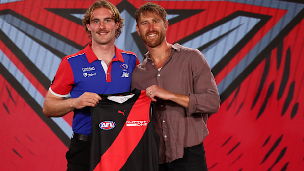 Dyson Sharp presented his jumper by Essendon champion Dyson Heppell.