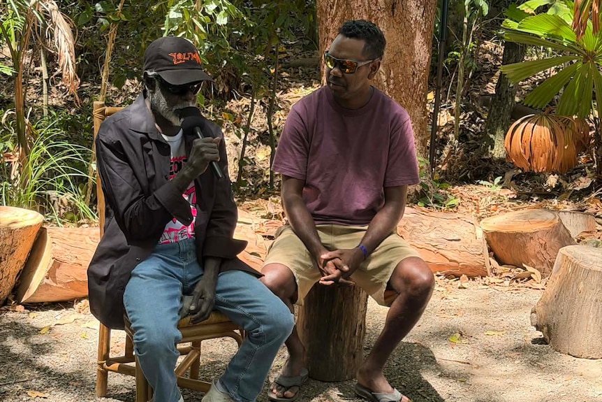 Two men from a band sitting down.