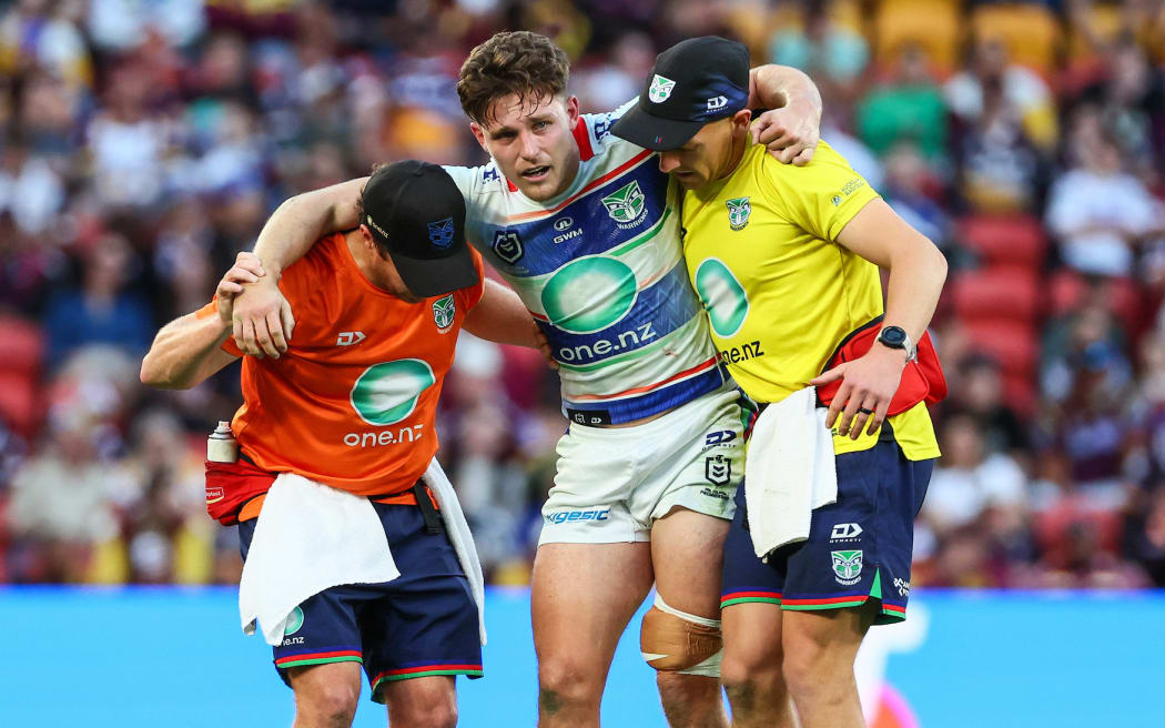 Luke Metcalf of the Warriors is helped off the field after an injury, Brisbane Broncos v NZ Warriors.