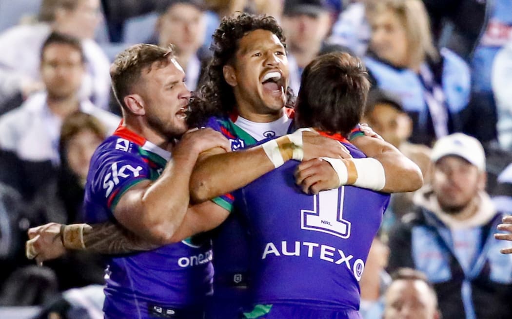 Dallin Watene-Zelezniak celebrates with teammates after scoring. Cronulla Sharks v One NZ Warriors.