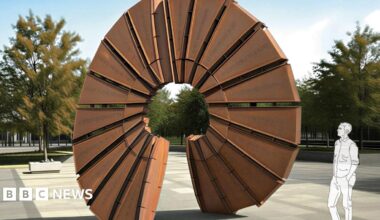 A computer generated image of a large circular weathered steel structure, about the height of two people. It is in the middle of an open town square. Trees in the background and a line drawing of a man stood next to the sculpture, looking up at it.