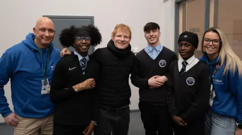 Coventry City Council Students and teachers posing with Ed Sheeran, inside a school