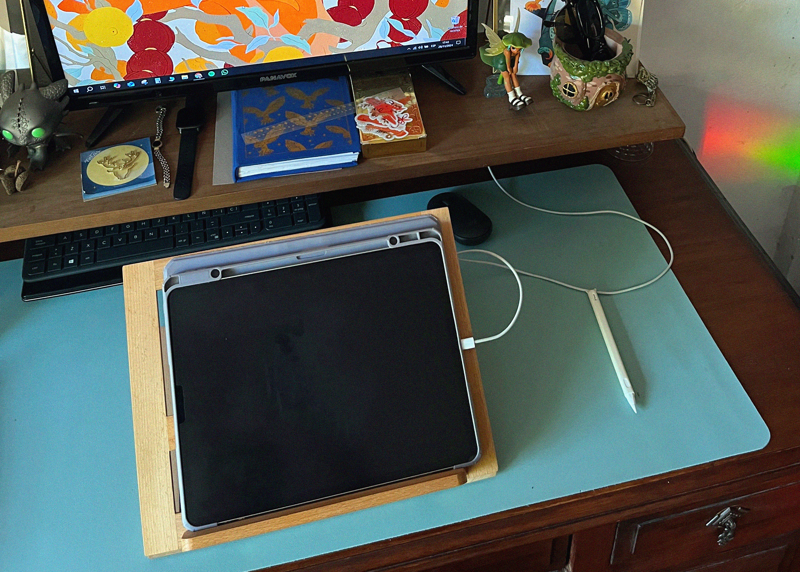 digital art accessories; a wooden easel with a tablet on it