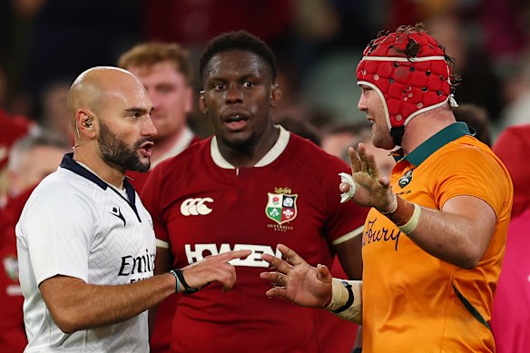 Harry Wilson speaks to referee Andrea Piardi about the end of the second Test at the MCG.